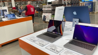 Laptops sit on display in a Costco warehouse.