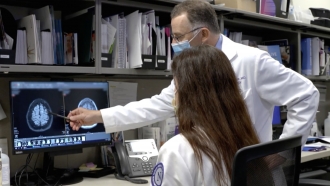 A doctor looking at scans of a patient's brain