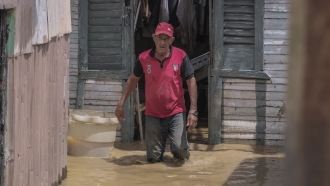 A man walks through floodwaters in the Dominican Republic.