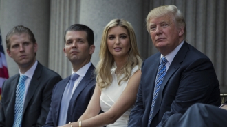 Donald Trump, right, sits with his children, from left, Eric Trump, Donald Trump Jr., and Ivanka Trump.