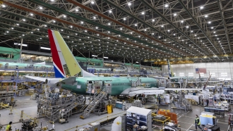 Boeing employees work on the 737 Max on the final assembly line at Boeing's Renton plant