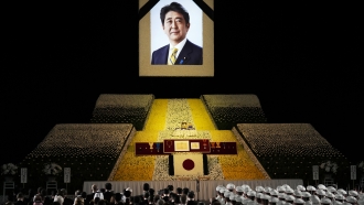 A portrait of former Japanese Prime Minister Abe Shinzo hangs on the stage during his state funeral.