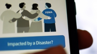 A phone displays the Federal Emergency Management Agency application