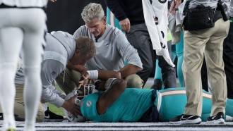 Miami Dolphins quarterback Tua Tagovailoa is attended to by medical staff after being sacked
