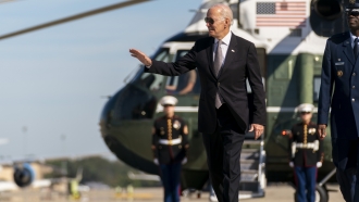 President Joe Biden waves.