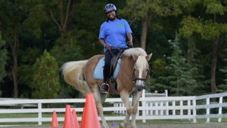 Dionne Williamson participates in a riding lesson at Cloverleaf Equine Center in Clifton, Va.