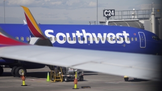 A Southwest Airlines jetliner sits at a gate on the C concourse of Denver International Airport