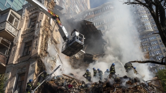 Firefighters work after a drone attack on buildings in Kyiv, Ukraine.