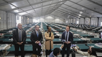 New York City officials hold a press conference in one of the migrant tents