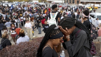 Student mourn after a school shooting.