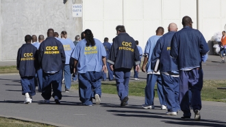 inmates walk through the exercise yard at California State Prison Sacramento, near Folsom, Calif.