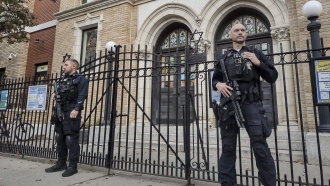 Police officers stand outside a synagogue.