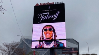 A sign announces the memorial service for slain rapper Takeoff at Atlanta's State Farm Arena.