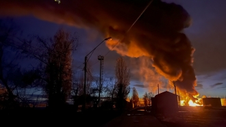 A plume of smoke rises during a fire caused by a Russian attack in Kherson, southern Ukraine.