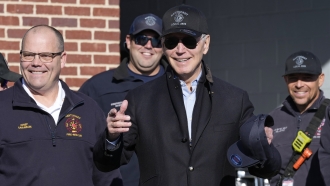 President Joe Biden, center, standing next to Nantucket Fire Department Chief Michael Cranson.