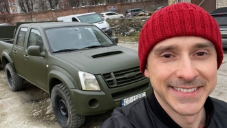 Max Titov is pictured with his modified truck.