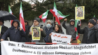 People protest in front of the Iranian embassy in Berlin, Germany.