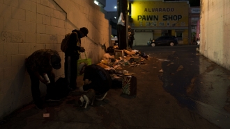 People smoking fentanyl in an alley.