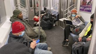 People sit on a subway.
