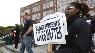 A student holds a sign following a Black Lives Matter rally.