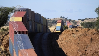 Shipping containers stacked along the Arizona-Mexico border.