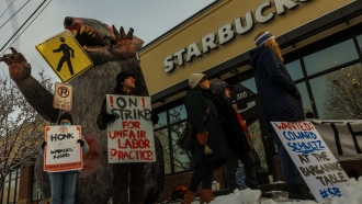 Starbucks workers protest in front of a store.