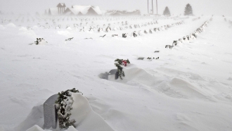 Rows of headstones at the North Dakota Veterans Cemetery blanketed by drifting snow