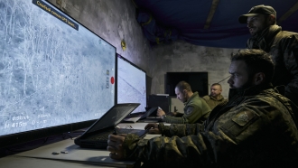 Ukrainian soldiers watch drone feeds from an underground command center in Bakhmut, Donetsk region, Ukraine
