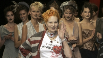 Fashion maverick Vivienne Westwood salutes the public in front of models after her Spring/Summer 2006 collection presentation