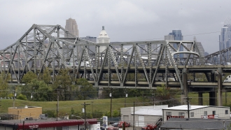 Traffic on the Brent Spence Bridge passes in front of the Cincinnati skyline while crossing the Ohio River
