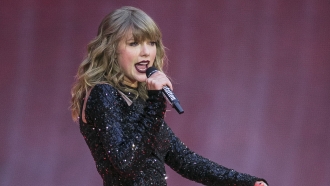 Taylor Swift sings on stage.