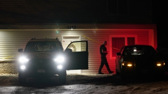 A private security officer walks to his car in front of the house in Moscow, Idaho
