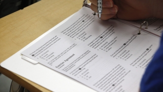 a student looks at questions during a college test preparation class at Holton Arms School in Bethesda, Md.