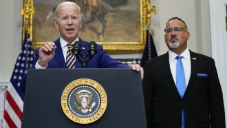President Joe Biden speaks about student loan debt forgiveness in the Roosevelt Room of the White House.