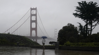 A rainy street near the Golden Gate Bridge is shown.