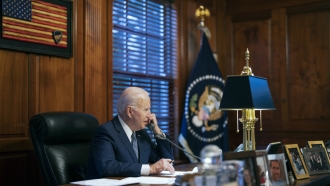 President Joe Biden speaks on the phone.