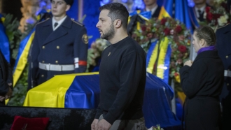 Ukrainian President Volodymyr Zelenskyy pays his respects to victims of a deadly helicopter crash during a farewell ceremony
