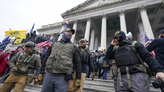 Members of the Oath Keepers extremist group stand on the East Front of the U.S. Capitol.
