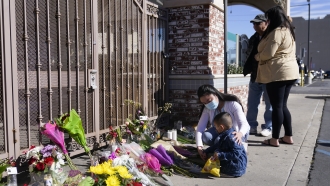 People pay their respects outside Star Ballroom Dance Studio.