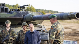 German Chancellor Olaf Scholz stands with German army Bundeswehr soldiers