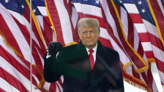 President Donald Trump gestures as he arrives to speak at a rally.