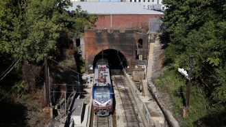 An Amtrak train emerges from the Baltimore and Potomac Tunnel in Baltimore, Maryland