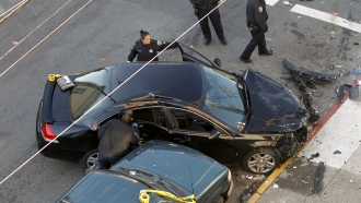 San Francisco police investigate vehicles at the scene of a two car vehicle crash that left two people dead