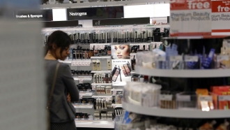 A shopper looks through the cosmetic department at a Target store.