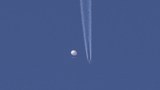 A large balloon drifts in the sky.