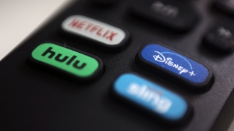 A remote shows buttons for multiple streaming services.
