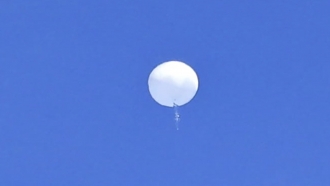 a large balloon drifts above the Atlantic Ocean, just off the coast of the Carolinas