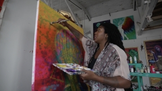 A woman painting on a canvas