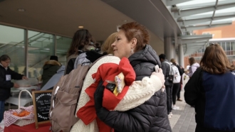 Free Moms founder Nancy Nelson hugs a student