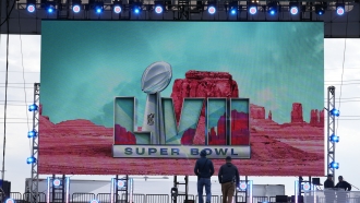 A logo is flashed on a stage outside State Farm Stadium ahead of Super Bowl 57.
